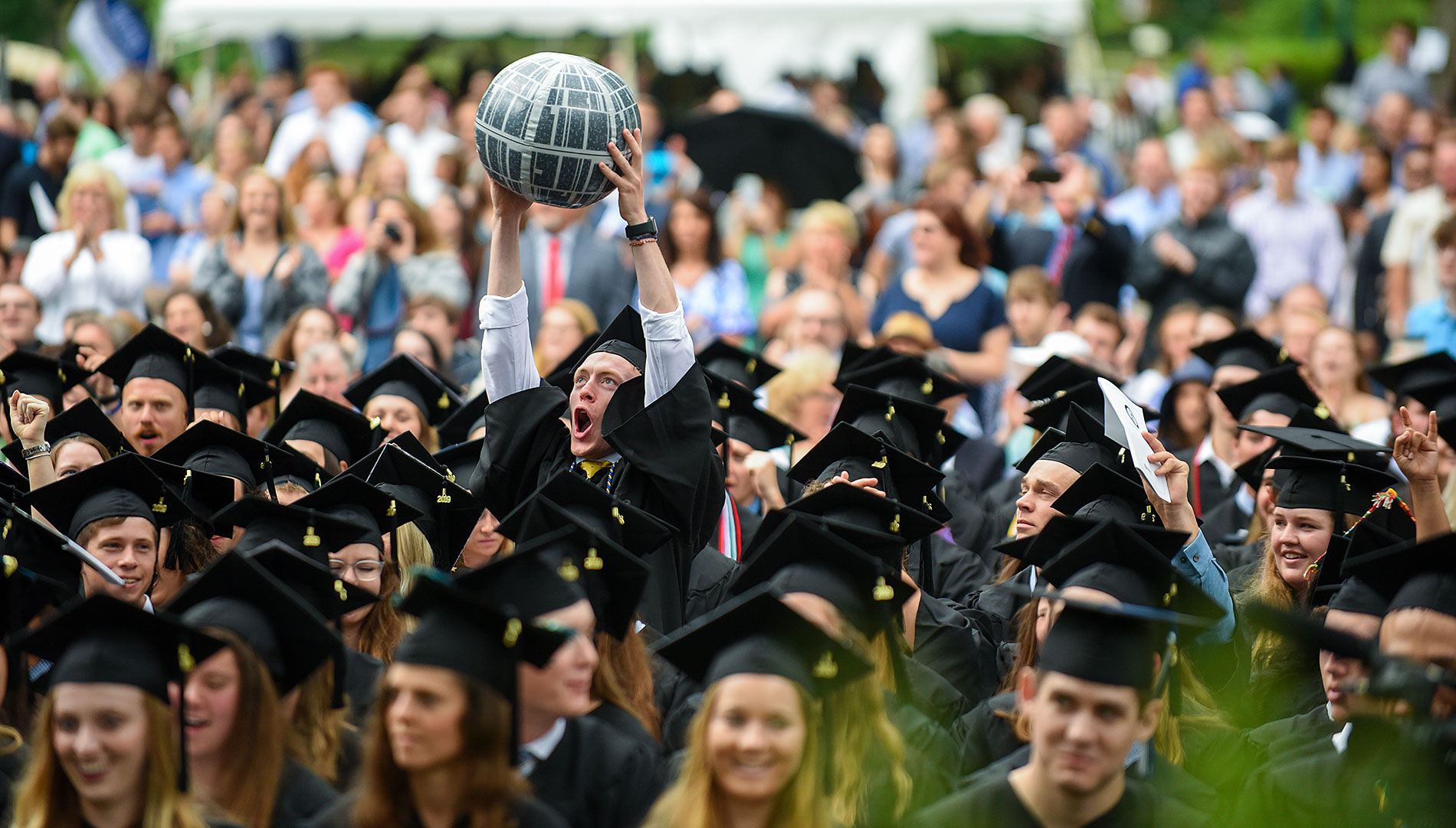 Students smiling at commencement